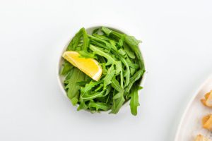 Bowl of rucola with lemon slice