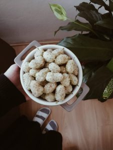Person holding bowl of white mulberry