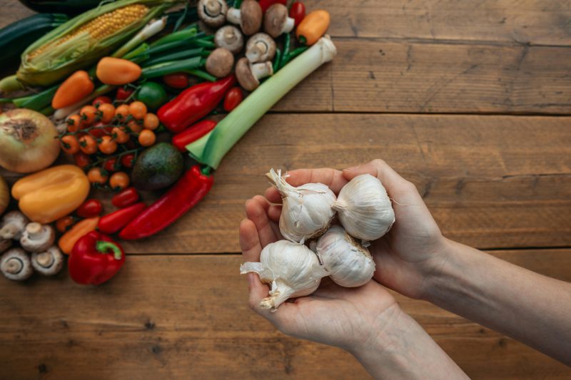 Photograph of garlic bulbs on a person s hands